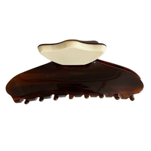 Elegant tortoiseshell claw clip with striped acetate finish for sophisticated hair styling