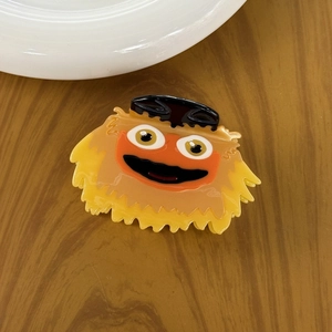 Funny yellow and orange cartoon monster hair claw clip made of smooth acetate material