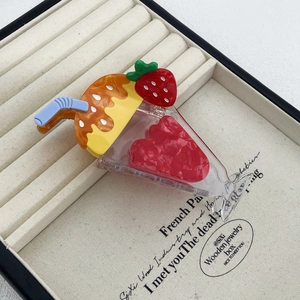 Detailed view of an ice cream cup shaped hair claw clip with colorful acetate finish