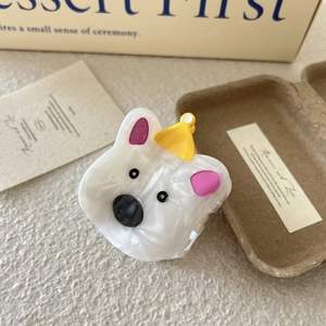 Detailed view of Westie dog hair claw clip made of white acetate with marbled texture