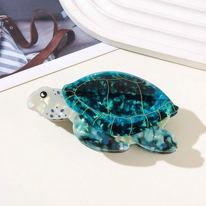 Detail view of the tortoise hair claw made of premium ocean blue marbled acetate material