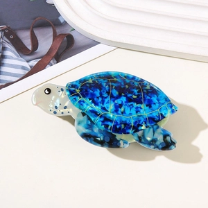 Elegant sea turtle hair claw clip with blue marble pattern acetate and golden shell details