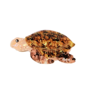 Ocean turtle hair claw clip with brown tortoiseshell texture and gold accents on white base