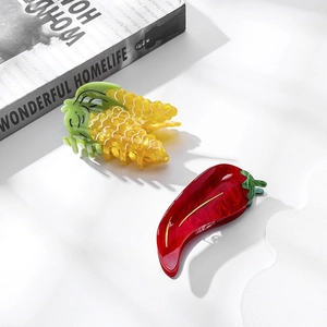 Unique corn and red chili pepper acetate hair claws set on minimalist background