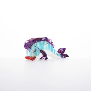 Detailed macro view of acetate tropical fish hair claw clip with pearlescent finish