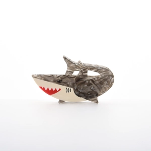 Detail view of tropical fish hair claw clip with marble texture and white serrated teeth