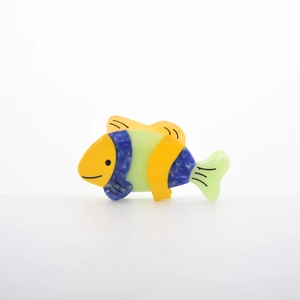 Macro detail of tropical fish hair claw clip featuring yellow and blue marble acetate finish