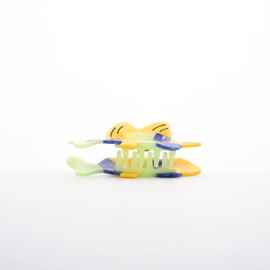 Detail of tropical fish hair claw clip made with colorful yellow and blue acetate material