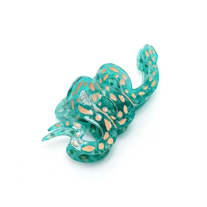Pince à cheveux en acétate bleu en forme de serpent avec des motifs à pois oranges