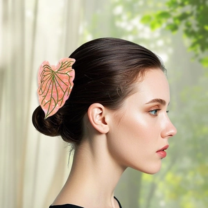 Pink leaf acetate hair claw clip with marble texture and green veins on female model