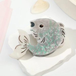 Elegant fish-shaped acetate hair claw clip with pearl luster and green scale patterns