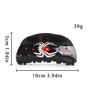 Détail d'une grande pince à cheveux araignée noire avec strass rouges et mesures de 10cm