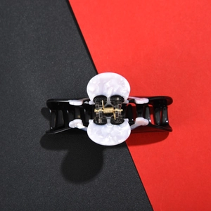 Macro shot of large acetate hair claw clip with black and white marble pattern design