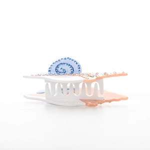 Détail d'une pince à cheveux en acétate avec coquillage, étoile de mer et strass bleus
