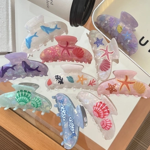 Elegant ocean themed acetate hair claws featuring starfish and seashell designs