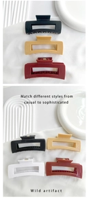 Detail of large rectangular hollow hair claws in black, beige, deep red and white