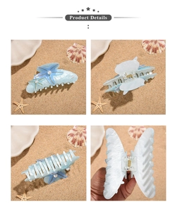 Detail view of ocean-themed starfish hair claw clips with pearls and marble finish