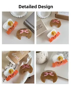 Close-up of creative food-shaped hair claws featuring fried egg and croissant designs