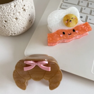 Creative egg bacon and croissant hair claws with cute smile and pink bow accents