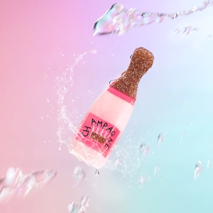 Detail of pink champagne bottle hair claw with rose gold glitter and water splash