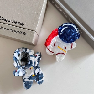 Creative astronaut acetate hair claws with marble texture and star patterns in red and blue