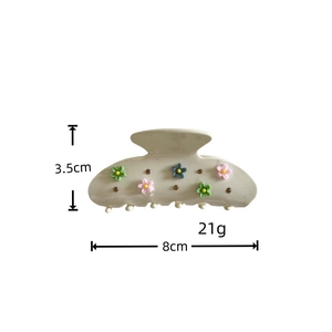 Detail view of cream hair claw clip with colorful floral pattern and 8cm size dimensions