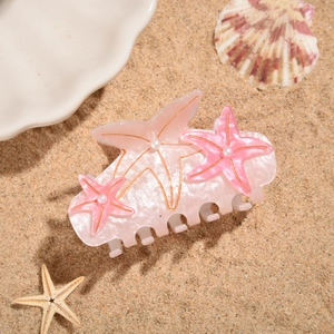 Close-up of ocean series hair claw with resin starfish, pearls and shimmering finish