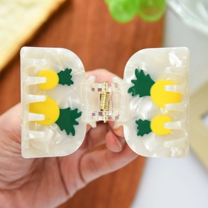 Elegant marble cream hair claw clip with yellow pineapple patterns and gold spring