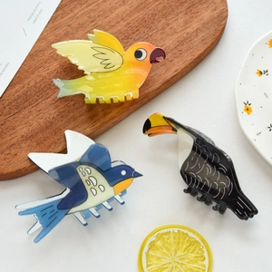 Detailed view of colorful parrot and swallow bird hair claws in high-quality resin finish