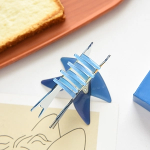 Detail of blue translucent star hair claw clip with shimmering glitter finish and acrylic teeth