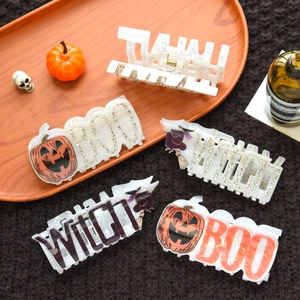 Detailed macro view of assorted Halloween claw clips with pumpkin and witch motifs