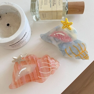 Elegant ocean conch acetate hair claw clips in peach and marble grey with starfish detail