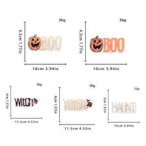 Detailed view of Halloween hair claws featuring pumpkin and ghost designs with rhinestones