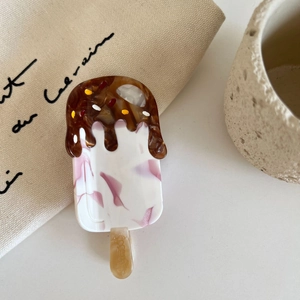 Macro shot of an acetate ice cream hair claw clip with chocolate and sprinkle details