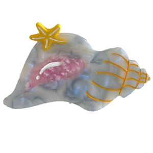 Ocean-themed seashell hair claw with acetate marble texture and yellow starfish design