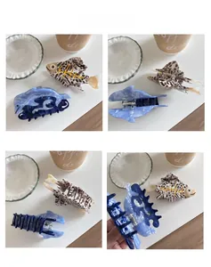 Detail view of acetate fish and dolphin hair claws with marble patterns and spring mechanisms