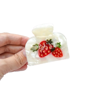 Acetate strawberry claw clip in cream white with red fruit patterns for women hair