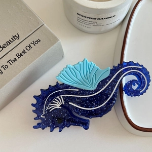 Detail of dark blue glitter seahorse hair claw clip with nautical resin patterns