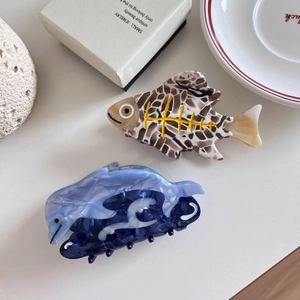 Handmade whale and dolphin shaped acetate hair claws in blue and tortoise patterns