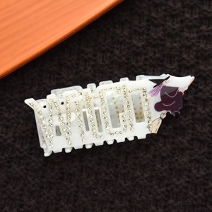 Detail of Halloween hair claw clip with crystal WITCH letters and witch graphic