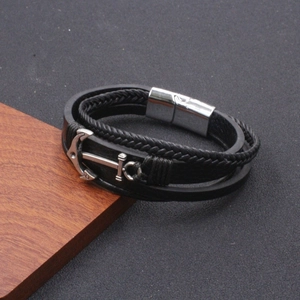 Macro detail of men's leather anchor bracelet with polished silver magnetic clasp