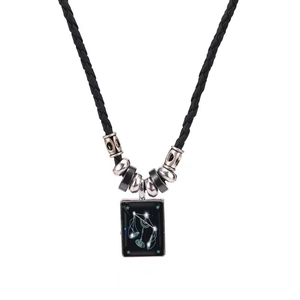 Macro view of woven black leather rope necklace with a Libra constellation pendant
