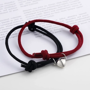 Magnetic heart bracelets for couples in black and red woven rope with silver charms