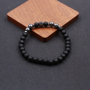 Classic beaded anklet featuring matte black stones and metallic hematite accents