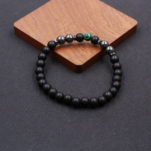 Handmade beaded anklet with matte black stones, metallic gray beads and green malachite accent