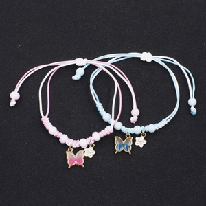 Matching butterfly and flower woven couple bracelets in pink and blue adjustable cords