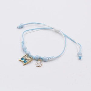 Detail view of woven light blue and white butterfly flower charm adjustable bracelet