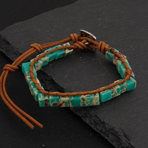 Close-up of bohemian leather wrap bracelet featuring turquoise emperor stones and metal button
