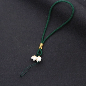 Handcrafted dark green braided phone charm strap with cute white ceramic lucky cat beads