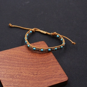 Ethnic bohemian hand-woven brown cord bracelet with turquoise beads and vintage silver charms